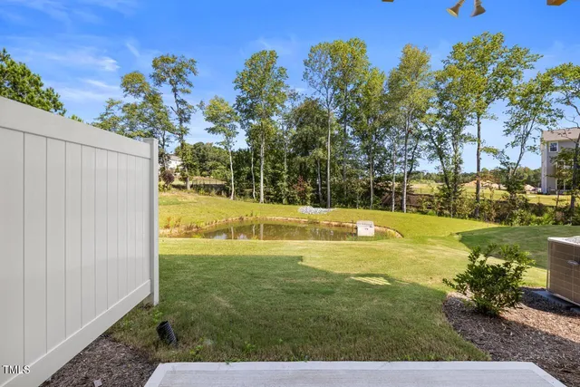 a view of a swimming pool with an outdoor seating and a yard