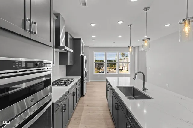 a kitchen with stove a sink and refrigerator