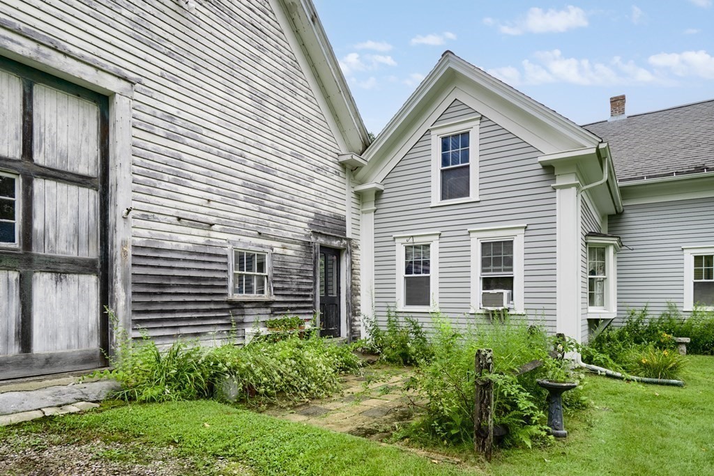 5 Leominster Road Princeton, MA 01541 - Photo 33 of 41 a view of a house with brick walls and a yard with plants