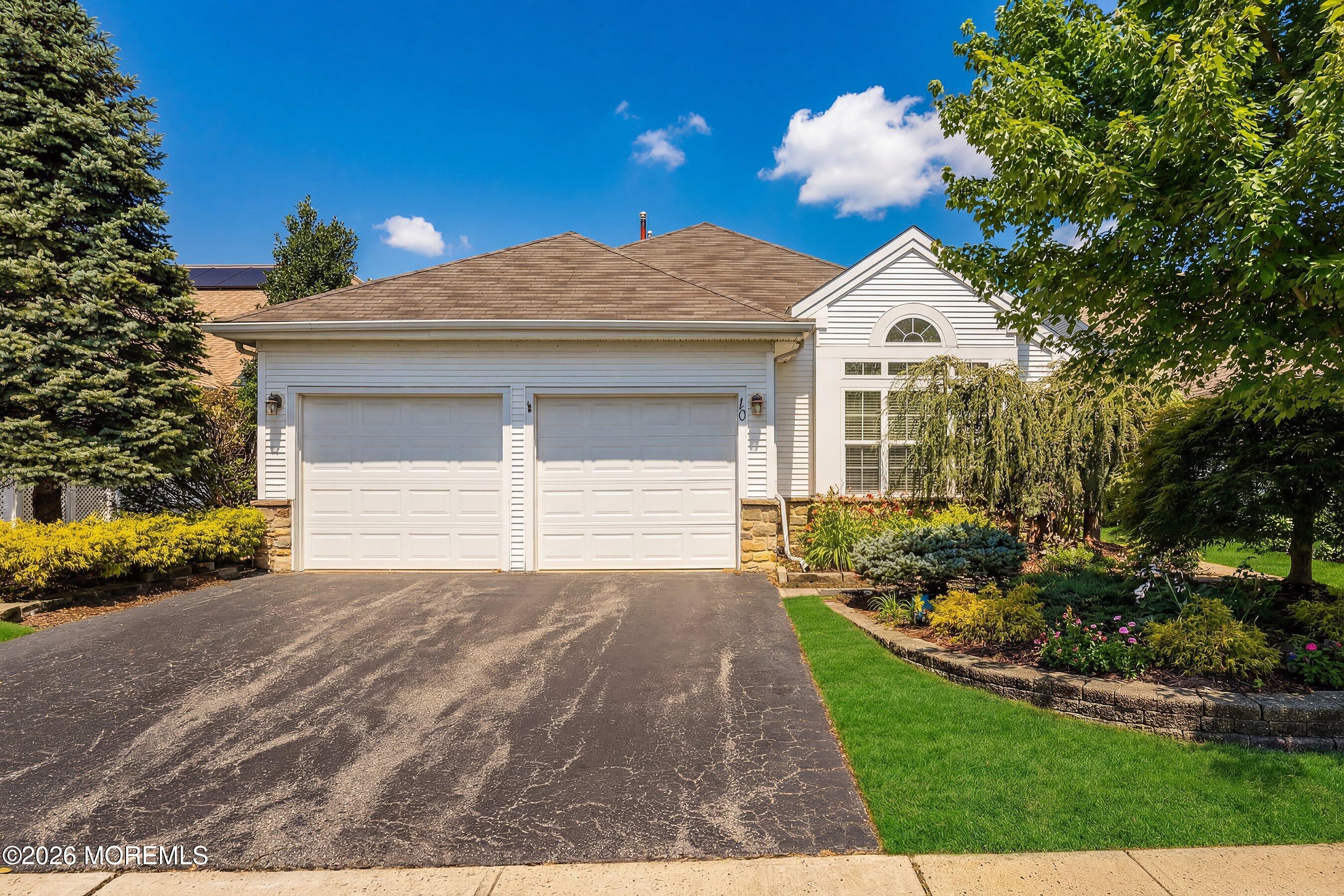 10 Arcadia Drive Manchester Township, NJ 08759 - Photo 2 of 37 a front view of a house with a yard and garage