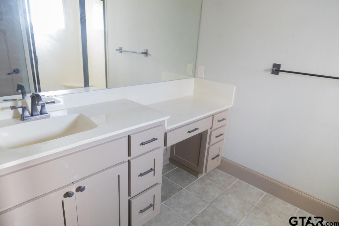 300 Rita Drive Lindale, TX 75771 - Photo 14 of 17 a bathroom with a sink and a mirror