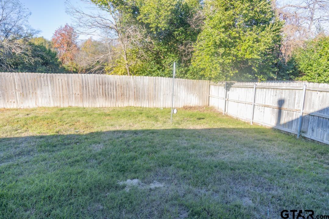 300 Rita Drive Lindale, TX 75771 - Photo 16 of 17 a view of yard with swimming pool and wooden fence