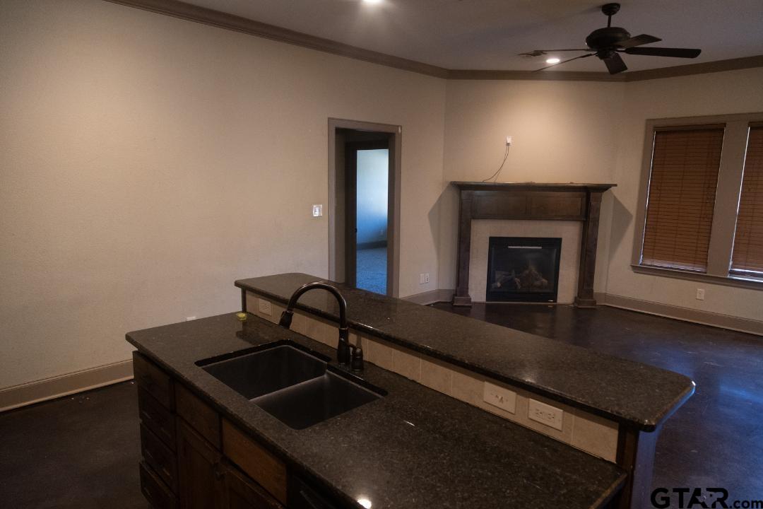 300 Rita Drive Lindale, TX 75771 - Photo 5 of 17 a kitchen with a sink and a fireplace