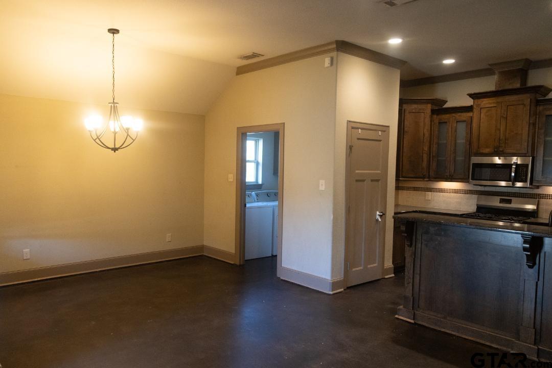 300 Rita Drive Lindale, TX 75771 - Photo 7 of 17 a view of a refrigerator in kitchen and wooden floor