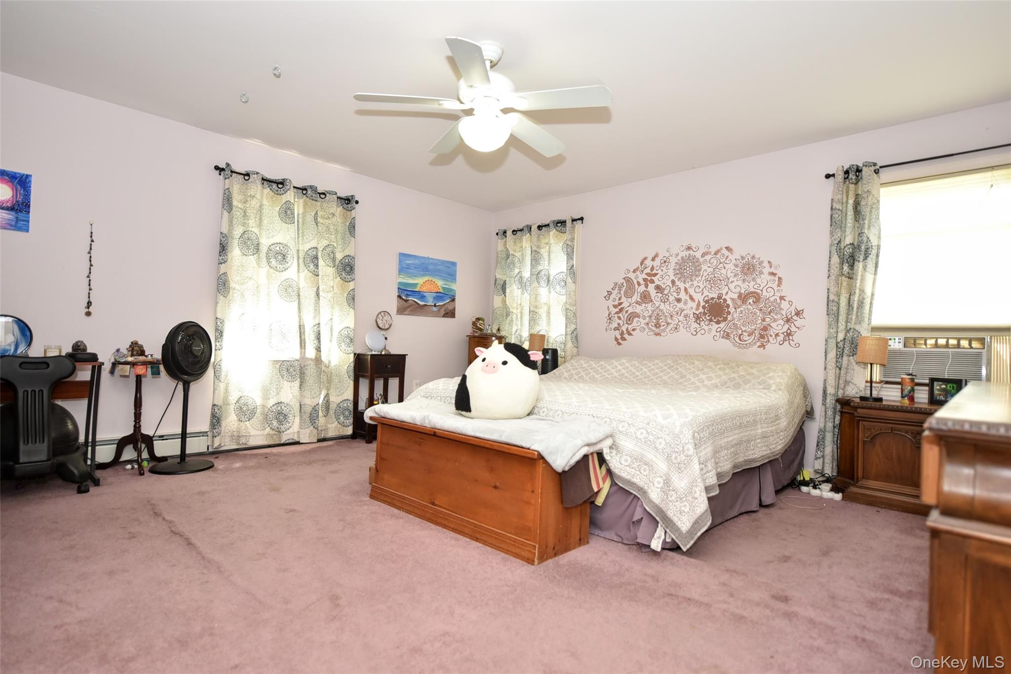 121 Hammond Road Thiells, NY 10984 - Photo 15 of 27 a spacious bedroom with a bed a couch and a chandelier