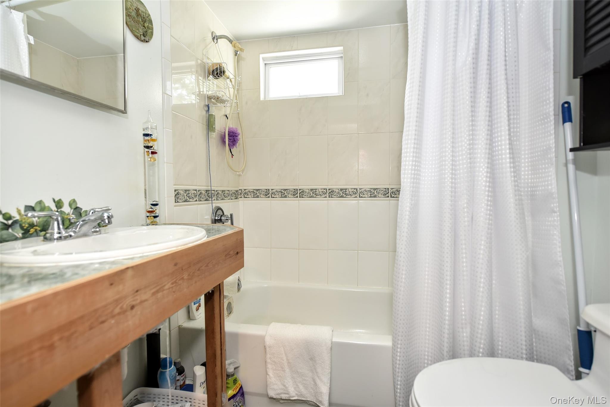 121 Hammond Road Thiells, NY 10984 - Photo 18 of 27 a bathroom with a sink a toilet and shower curtain