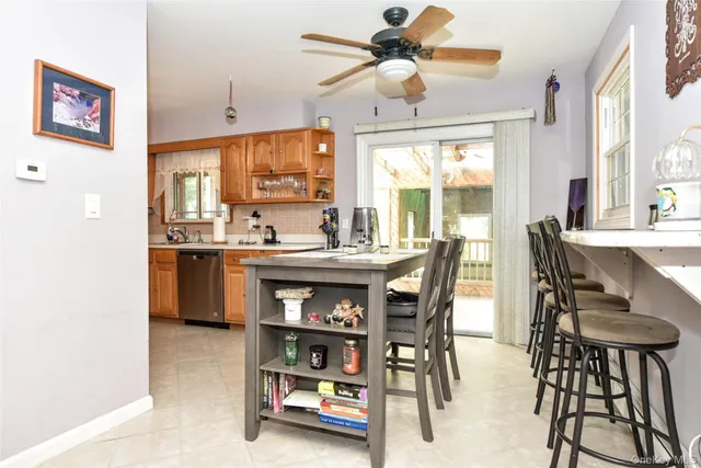 a dining room with stainless steel appliances a table and chairs