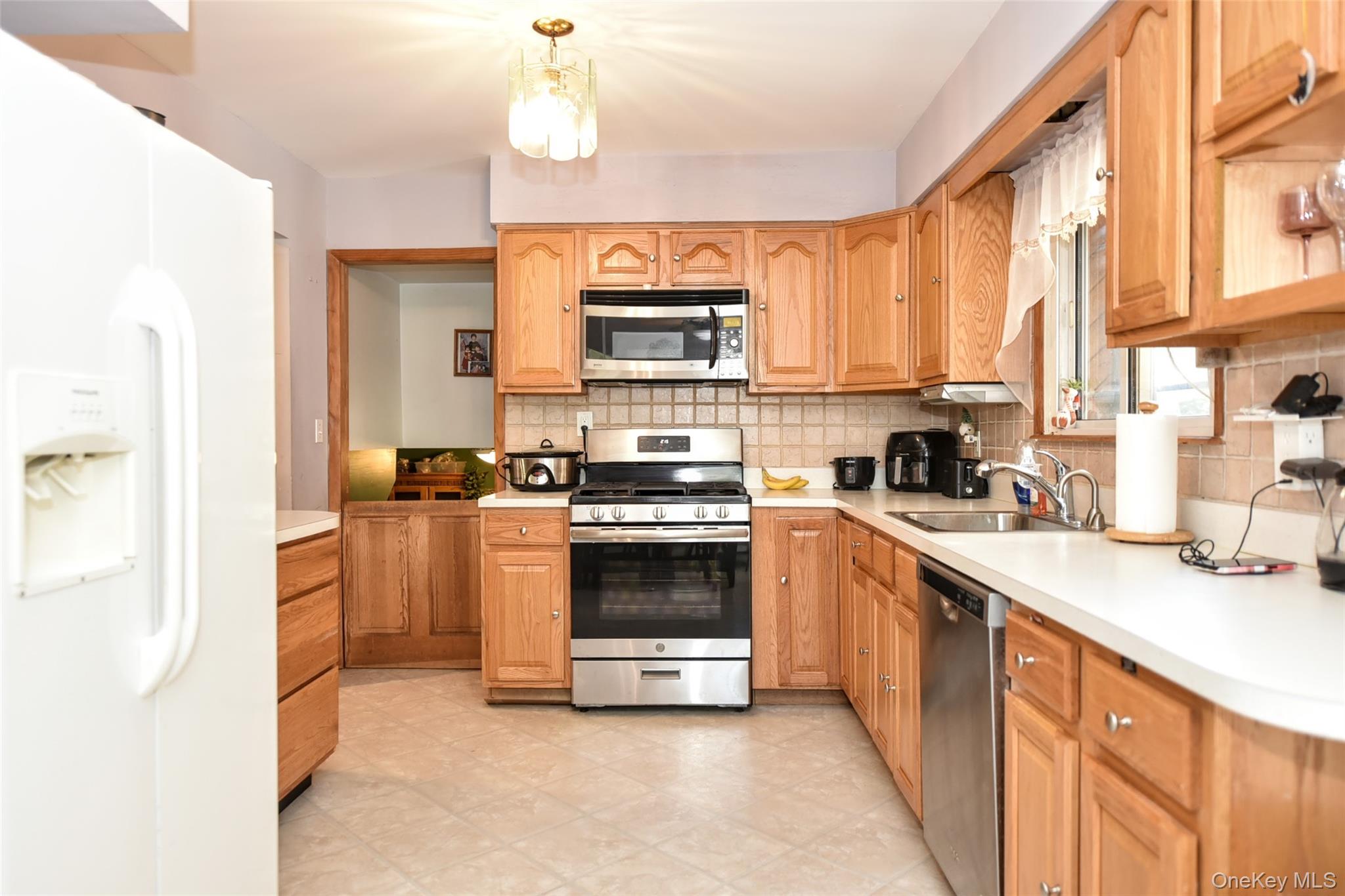 121 Hammond Road Thiells, NY 10984 - Photo 9 of 27 a kitchen with stainless steel appliances a stove a sink and a refrigerator