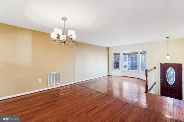 a view of a room with wooden floor