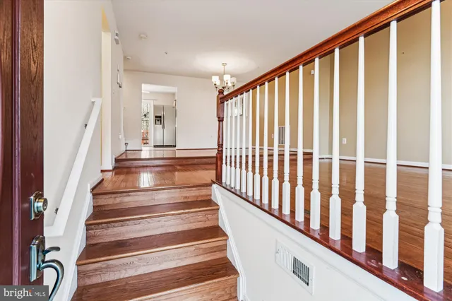 a view of entryway with wooden floor and stairs