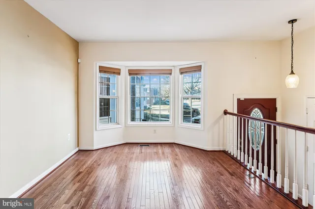 a view of a room with wooden floor and fan