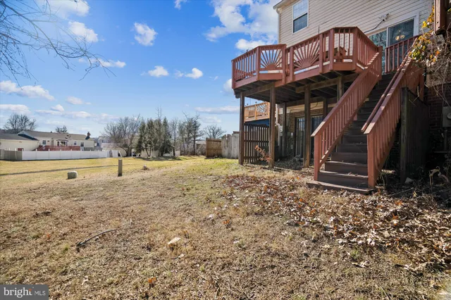 a view of a house with two chairs and potted plants