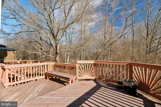 a view of wooden deck with a bench