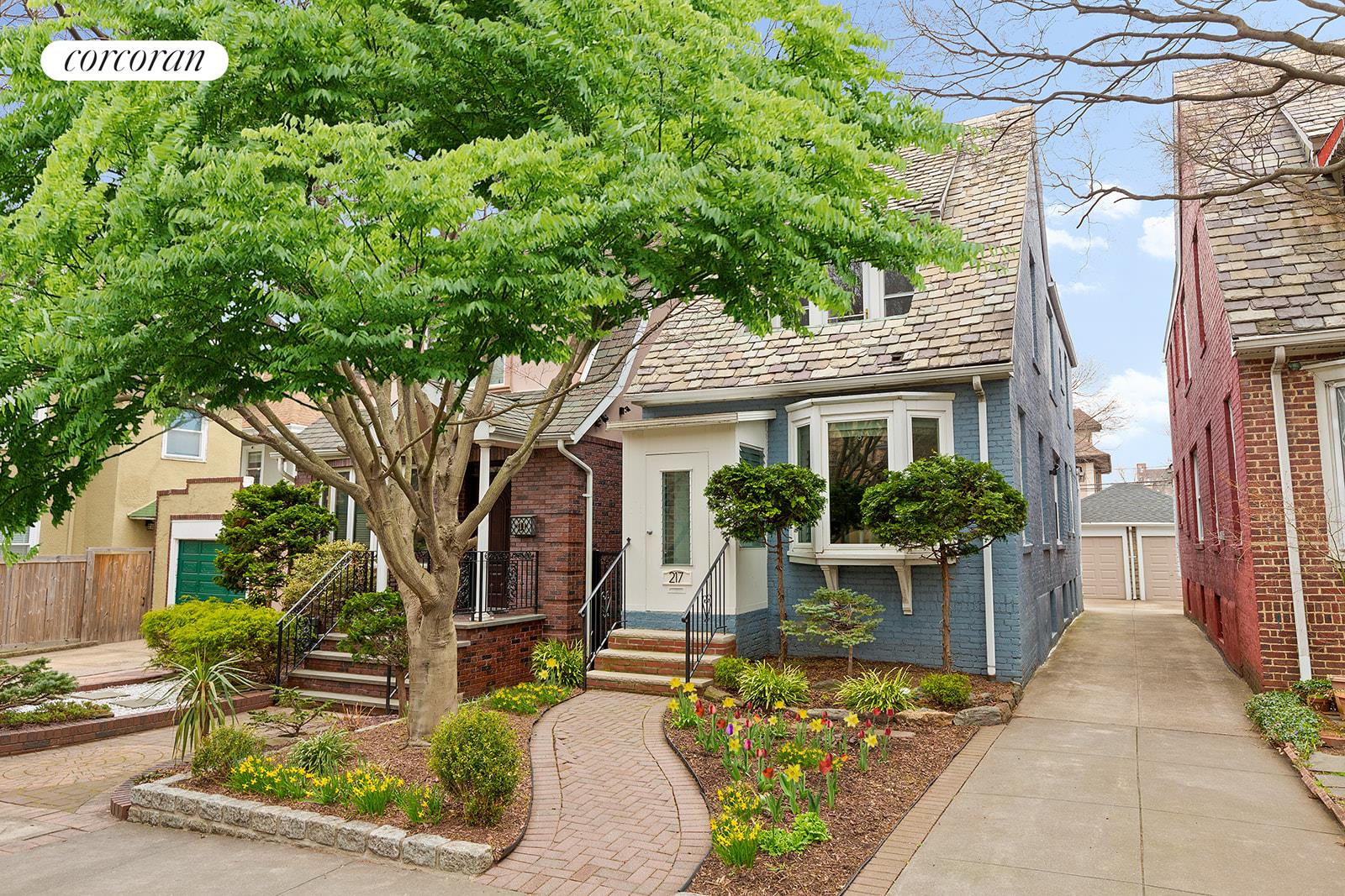 a front view of a house with garden