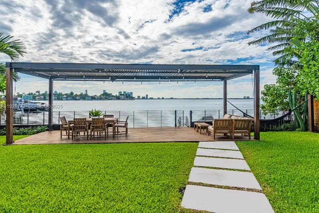 a front view of a house with garden and sitting area