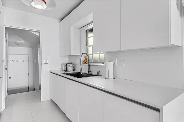 a kitchen with granite countertop a sink and a stove top oven
