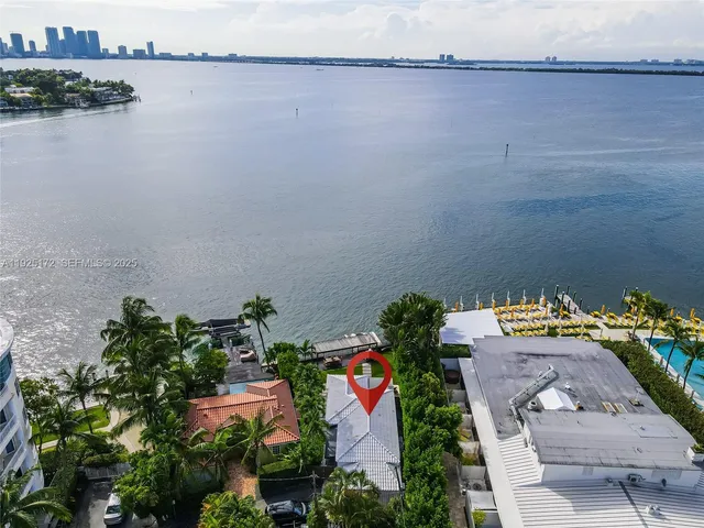 an aerial view of a house with a lake view