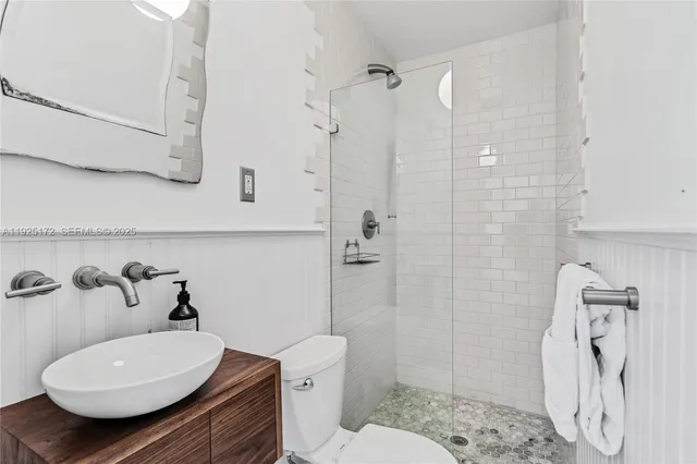 a bathroom with a sink toilet and shower