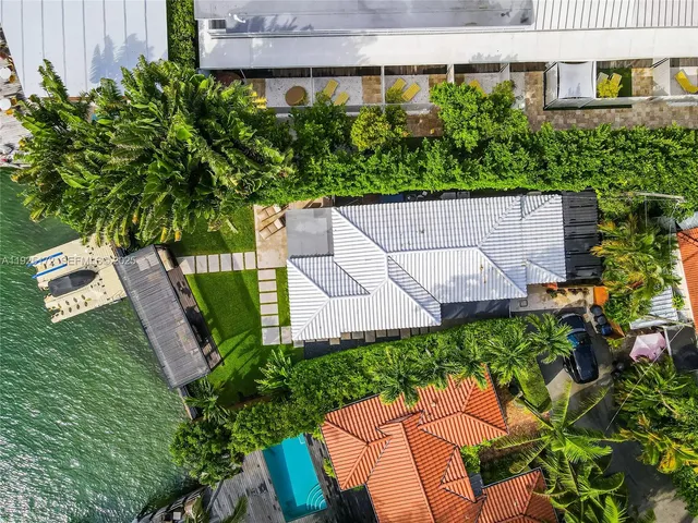 an aerial view of a house with garden space and street view