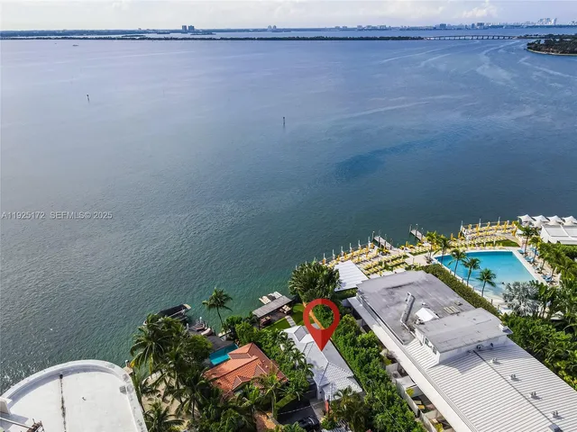 an aerial view of a house with a yard and lake view