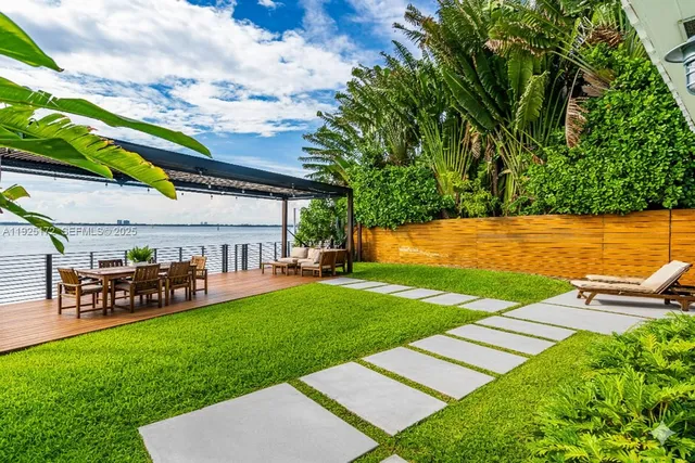 a view of a yard with a table and a chair