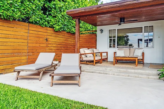 a view of backyard with seating space