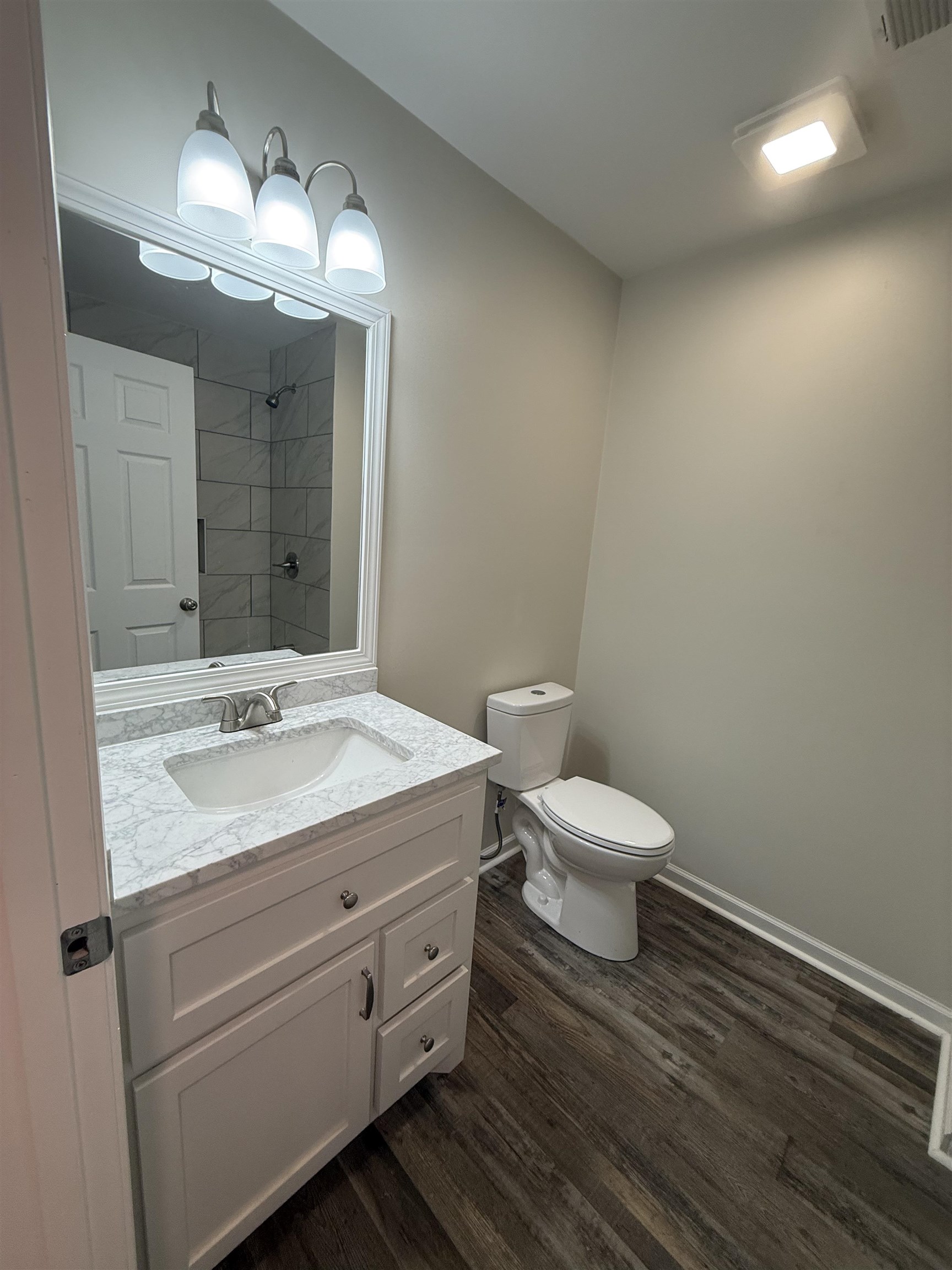1835 Pleasant Grove Road Moscow, TN 38057 - Photo 22 of 34 Modern bathroom featuring a white vanity with a marble-finish countertop, undermount sink, and brushed nickel faucet