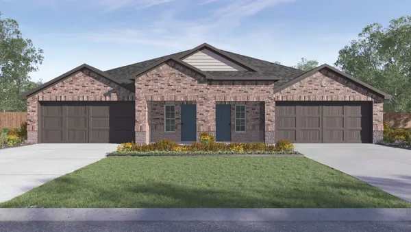 a front view of a house with a garden and yard