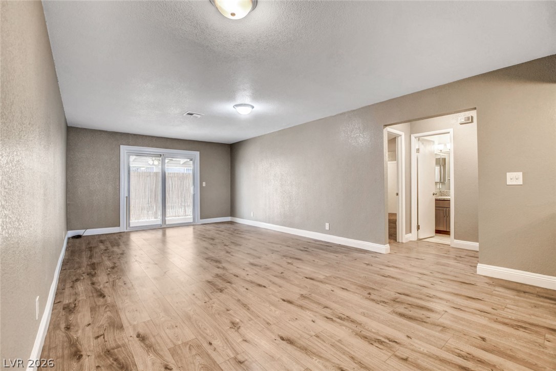 4367 South Mojave Road Las Vegas, NV 89121 - Photo 16 of 53 A spacious room offers ample natural light and durable wood-look flooring.