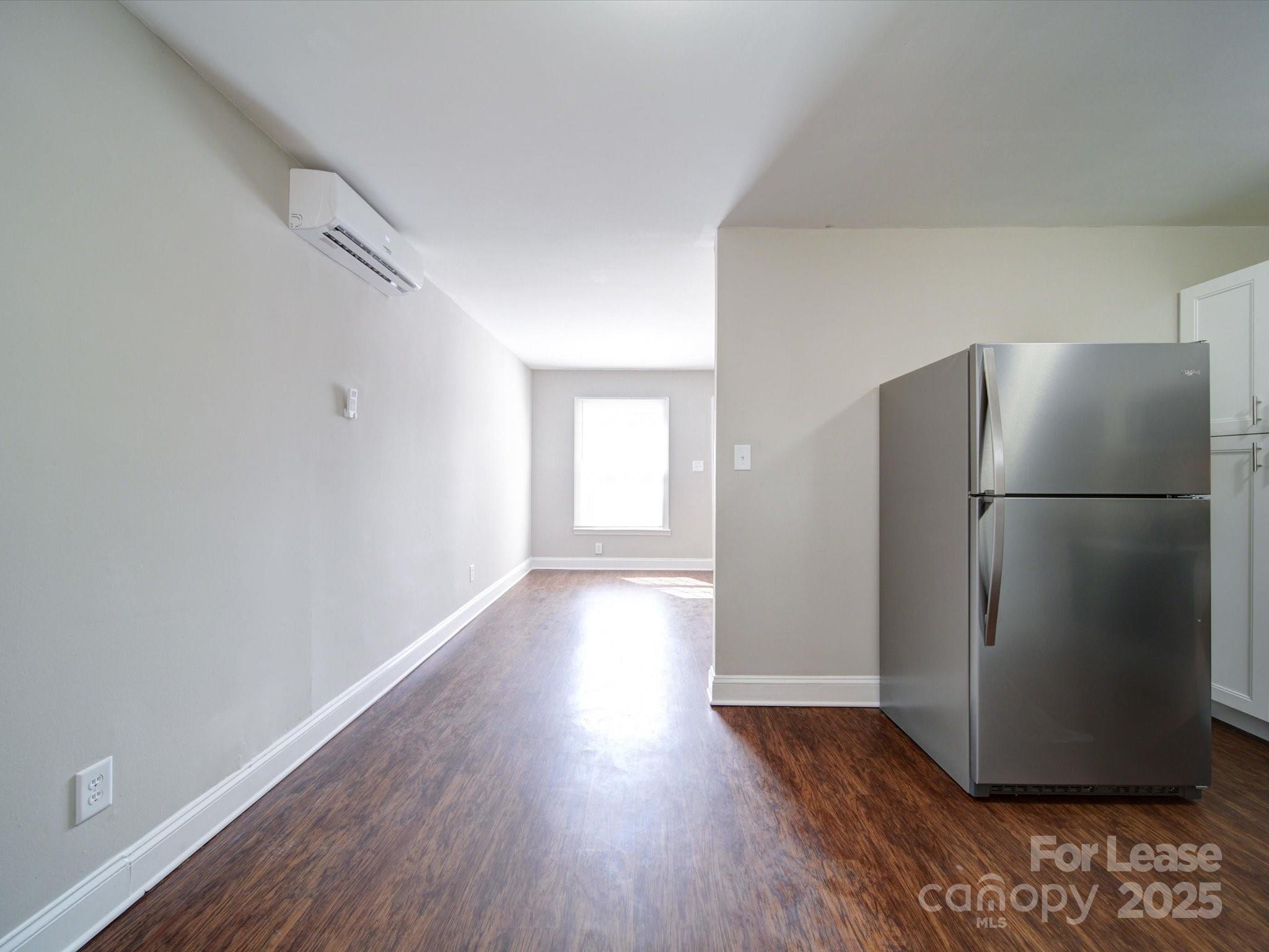 321 South Gardner Avenue, Unit 6 Charlotte, NC 28208 - Photo 14 of 35 a view of a refrigerator in kitchen and wooden floor