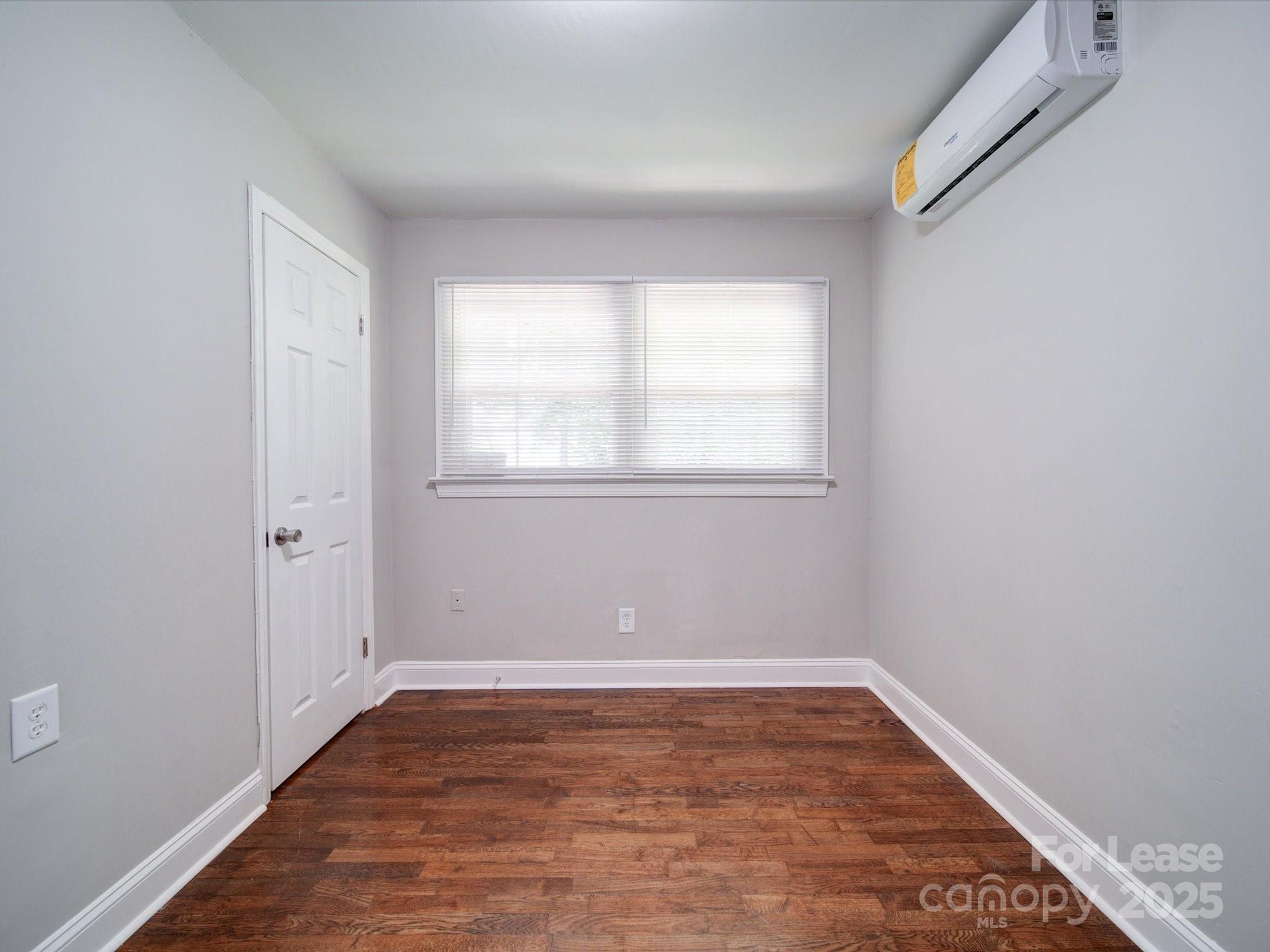 321 South Gardner Avenue, Unit 6 Charlotte, NC 28208 - Photo 21 of 35 an empty room with wooden floor and windows