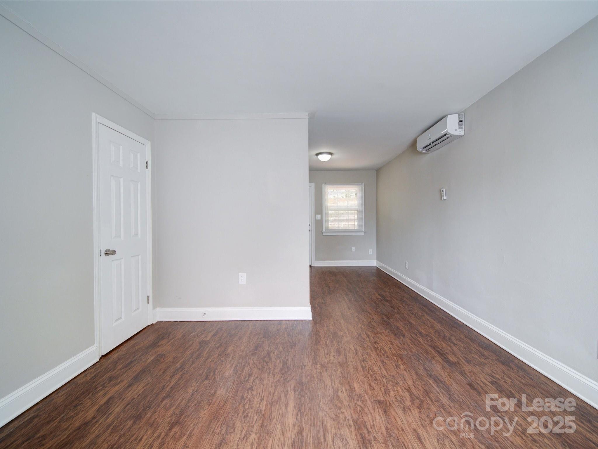 321 South Gardner Avenue, Unit 6 Charlotte, NC 28208 - Photo 3 of 35 an empty room with wooden floor and windows