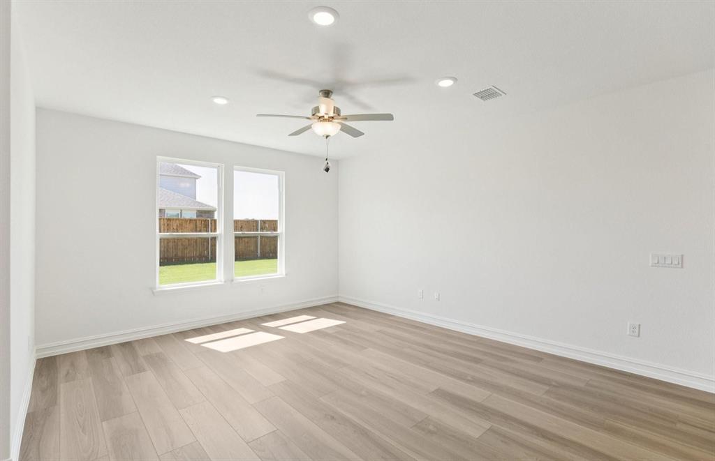 1616 Prosper Lane Anna, TX 75409 - Photo 4 of 12 a view of an empty room with a window and wooden floor