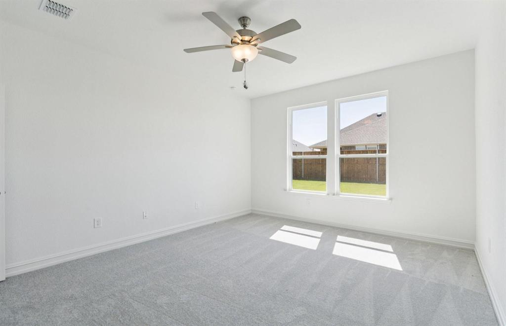 1616 Prosper Lane Anna, TX 75409 - Photo 5 of 12 an empty room with windows and fan