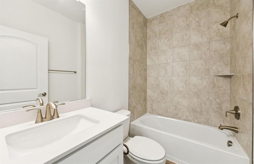 1616 Prosper Lane Anna, TX 75409 - Photo 9 of 12 a bathroom with a granite countertop sink mirror toilet and bathtub