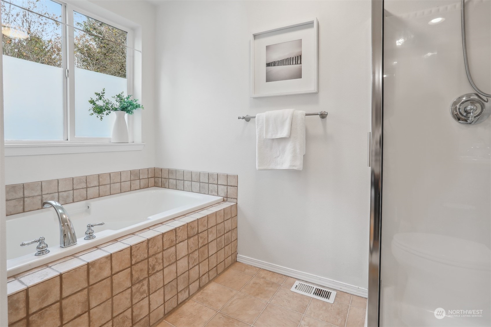 105 170th Street Southeast Bothell, WA 98012 - Photo 21 of 33 a bathroom with a tub a sink and a window