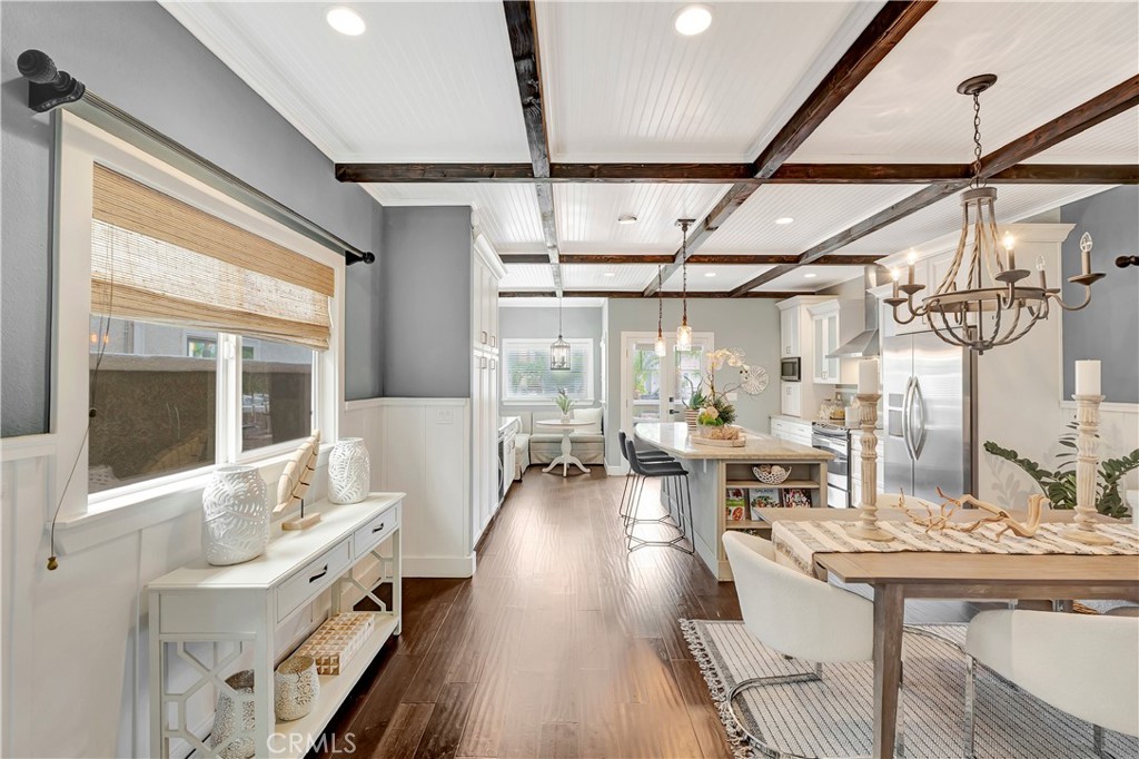 621 8th Street Huntington Beach, CA 92648 - Photo 12 of 58 a view of a dining room with furniture a chandelier and wooden floor