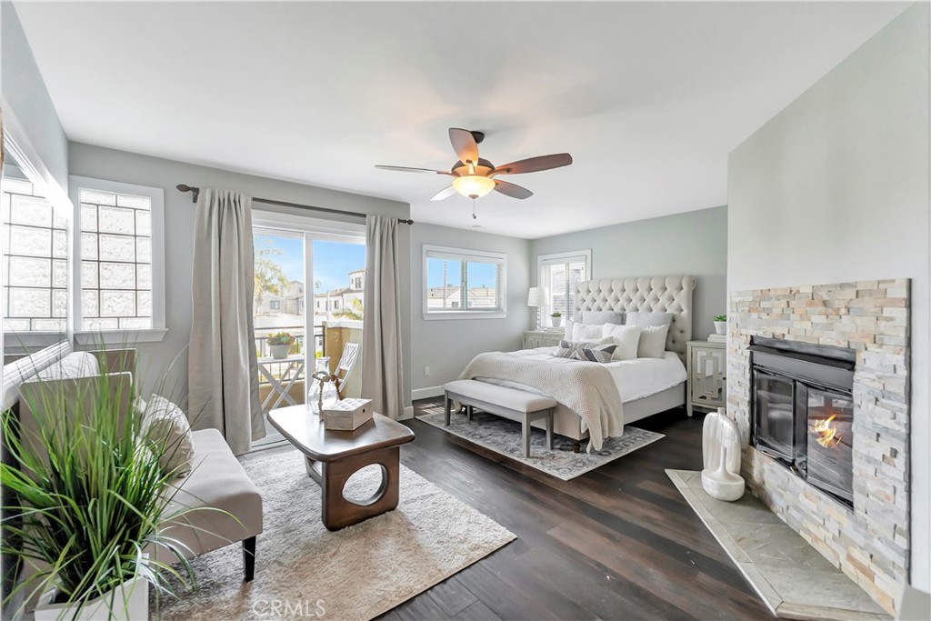 621 8th Street Huntington Beach, CA 92648 - Photo 22 of 58 a spacious bedroom with a bed a couch and a fireplace