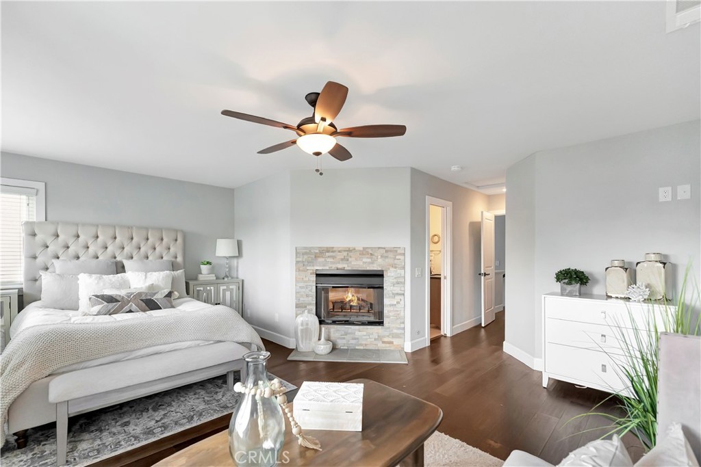 621 8th Street Huntington Beach, CA 92648 - Photo 23 of 58 a bedroom with a bed a couch and a fireplace