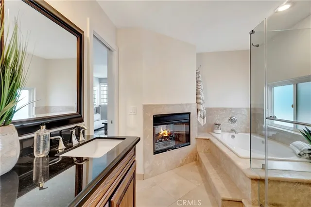 a bathroom with a granite countertop sink a mirror and shower