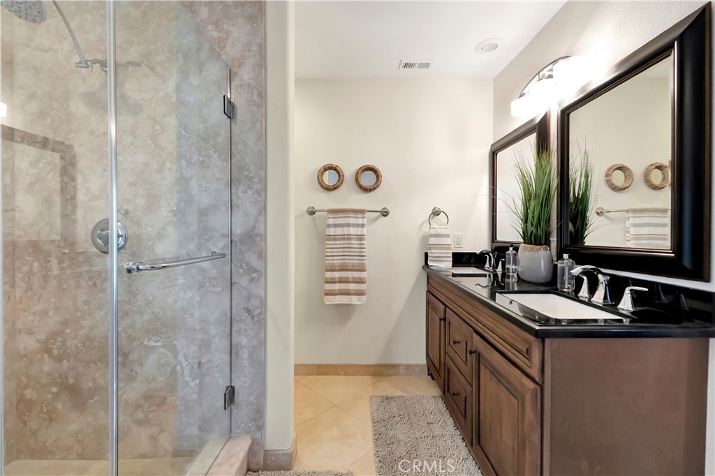 621 8th Street Huntington Beach, CA 92648 - Photo 28 of 58 a bathroom with a double vanity sink a mirror a window and a shower