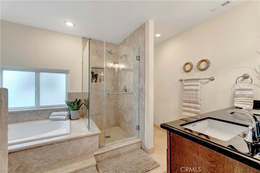621 8th Street Huntington Beach, CA 92648 - Photo 29 of 58 a bathroom with a granite countertop sink a mirror and shower
