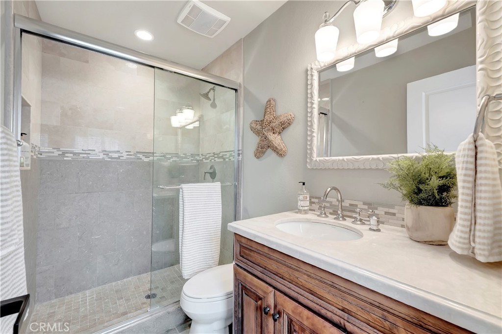 621 8th Street Huntington Beach, CA 92648 - Photo 34 of 58 a bathroom with a sink a toilet and shower