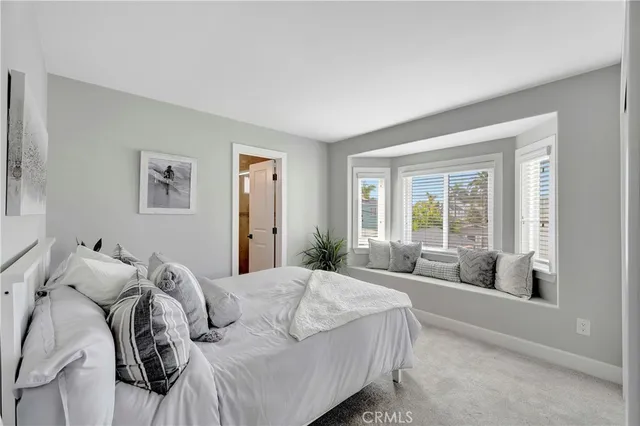 a bathroom with a granite countertop sink a toilet a mirror and shower