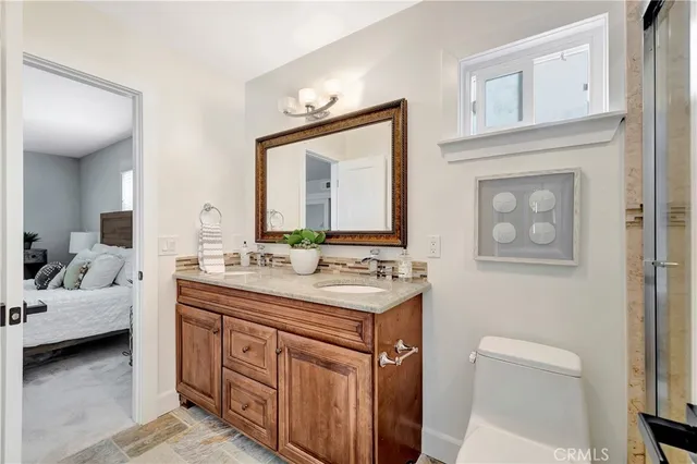 a bedroom with a bed and a large mirror