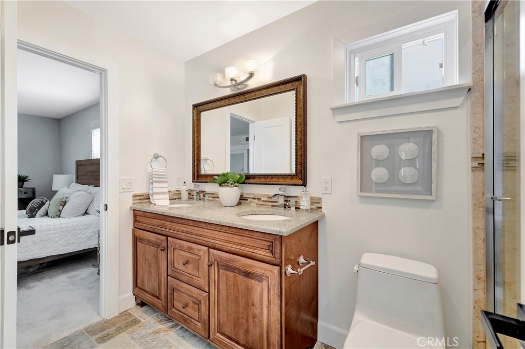 621 8th Street Huntington Beach, CA 92648 - Photo 37 of 58 a bathroom with a sink vanity and a mirror