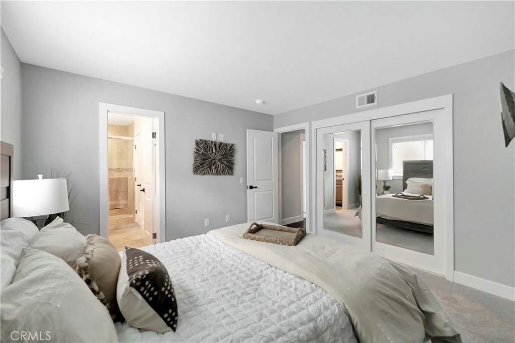 621 8th Street Huntington Beach, CA 92648 - Photo 40 of 58 a bedroom with a bed and a large mirror