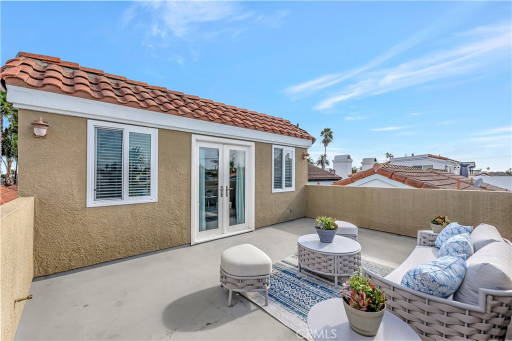621 8th Street Huntington Beach, CA 92648 - Photo 51 of 58 a view of a patio with couches table and chairs and potted plants