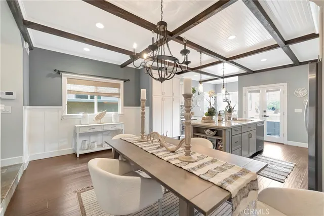 a kitchen with a white cabinets and chairs