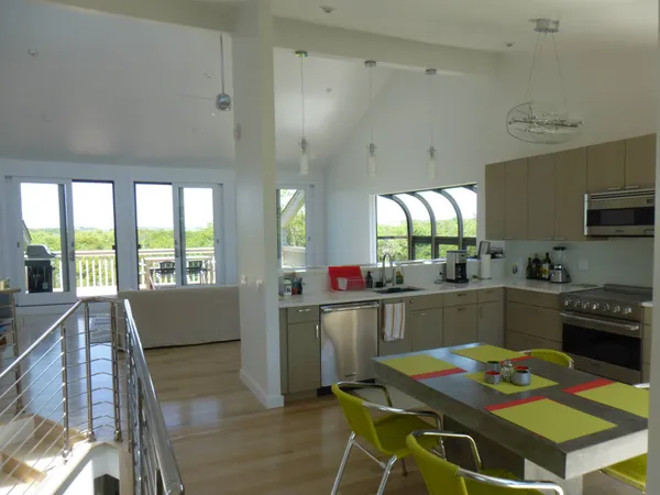 a kitchen with a table chairs stove and cabinets